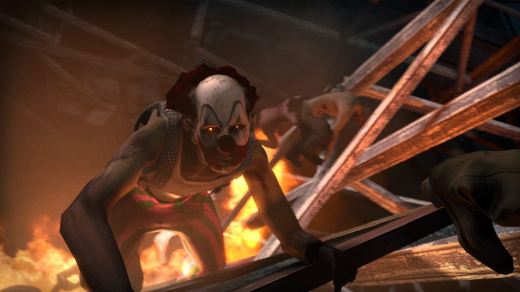 An infected clown crawls out of burning wreckage in Left 4 Dead 2.