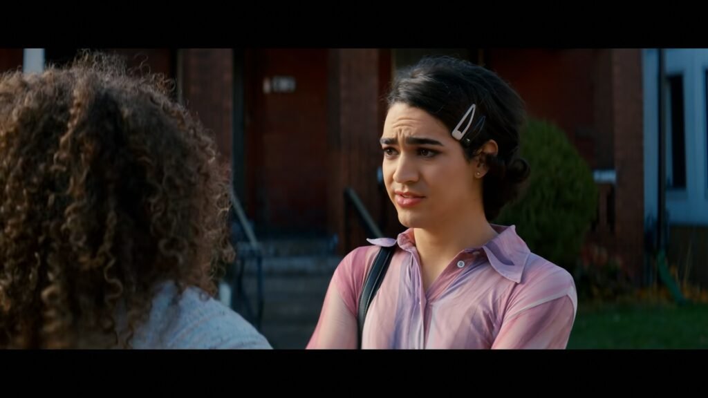 Miss Benny as Marco in Glamorous, talking to her mother in the street.