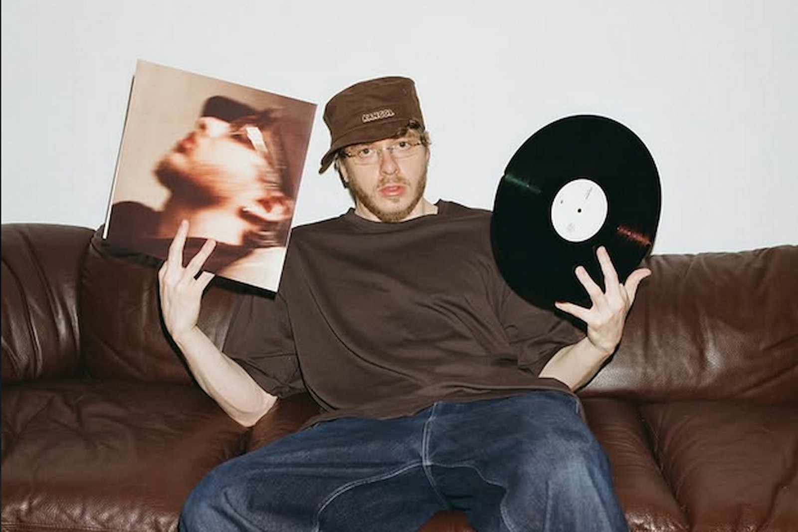 Jack Harlow holding his album on vinyl