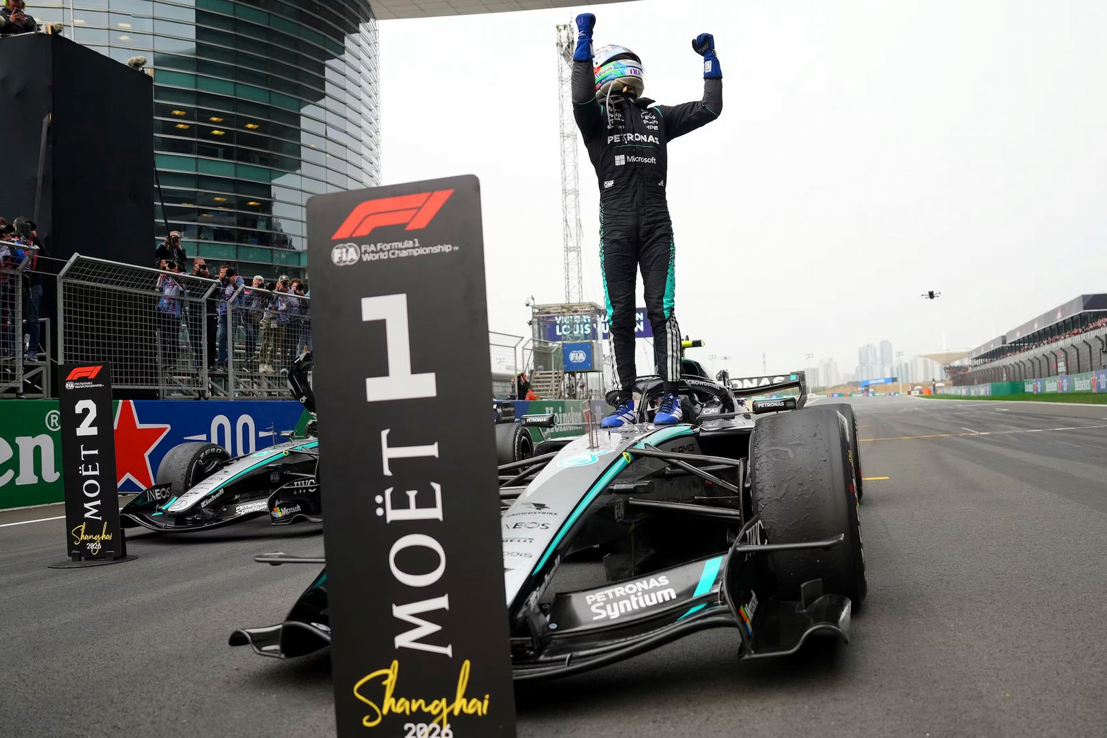 Kimi Antonelli celebrating his win on top of his Mercedes car