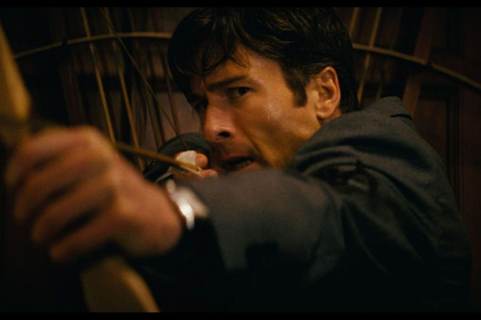 Still of Glen Powell holding a bow and arrow in How To Make A Killing.