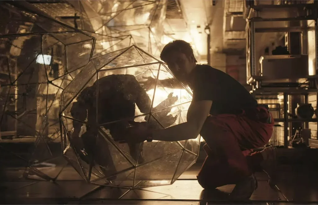 A still from Project Hail Mary. Ryland Grace is hugging Rocky.